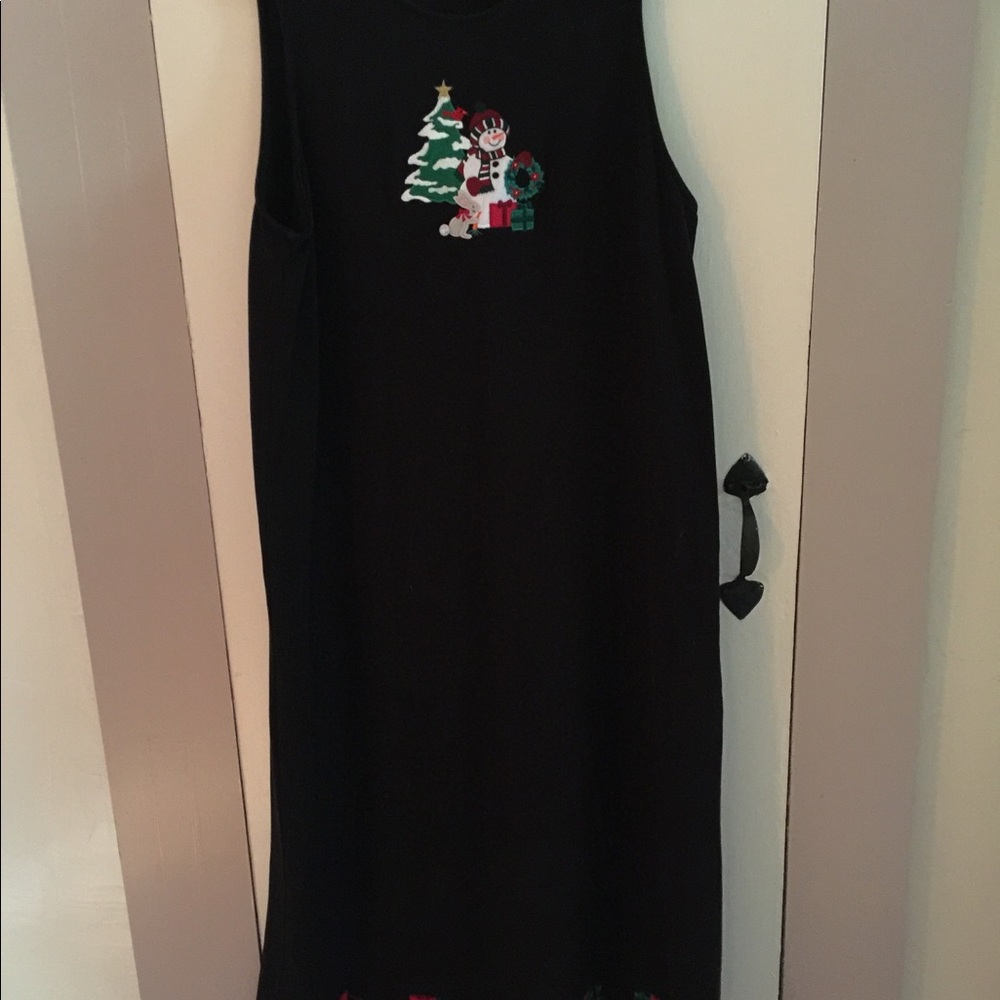 Black jumper with Christmas motifs embroidered around the bottom and back.